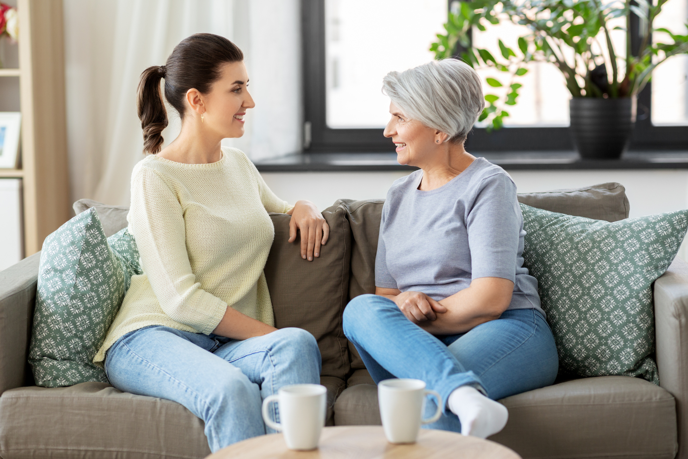 Senior Mother with Adult Daughter Talking at Home